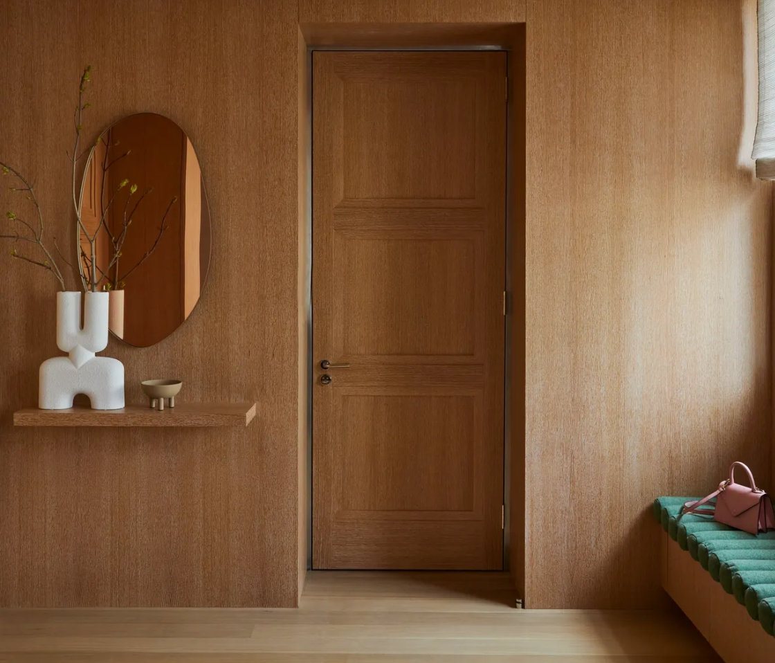 Wood door set in a paneled wall