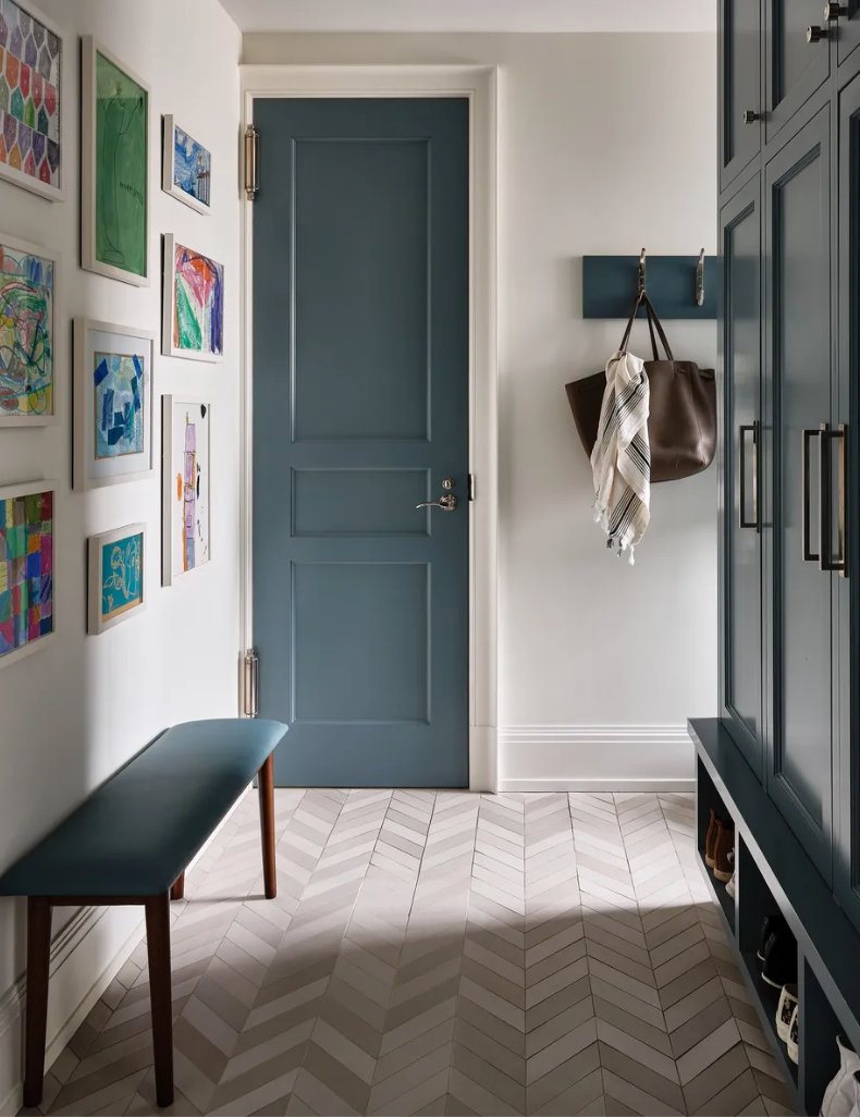 Entry with a painted paneled door